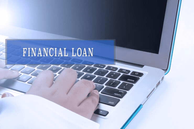 "Close-up of hands typing on a laptop keyboard with the text 'FINANCIAL LOAN' displayed on the screen, representing online loan application or digital financial services."