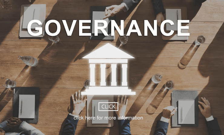 "Top view of a boardroom meeting with business professionals seated around a table, overlaid with the word 'Governance' and an icon of a government building, symbolizing corporate or institutional governance."