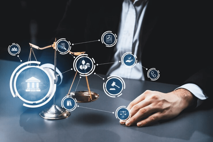 "Businessperson sitting beside golden scales of justice with digital legal and law-related icons overlay, symbolizing legal advice, law services, and digital transformation in the legal field."

